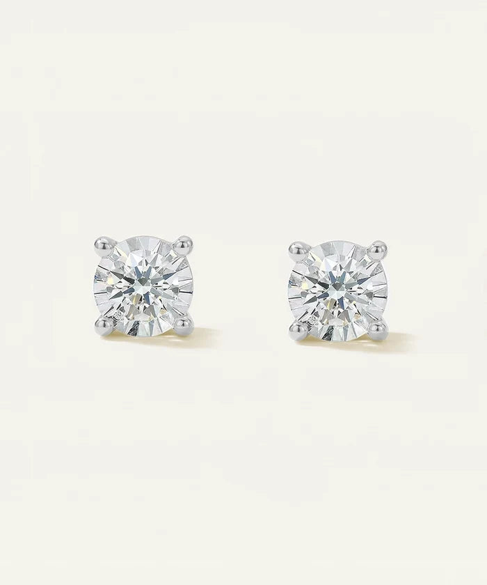 Pair of diamond stud earrings on a light gray background