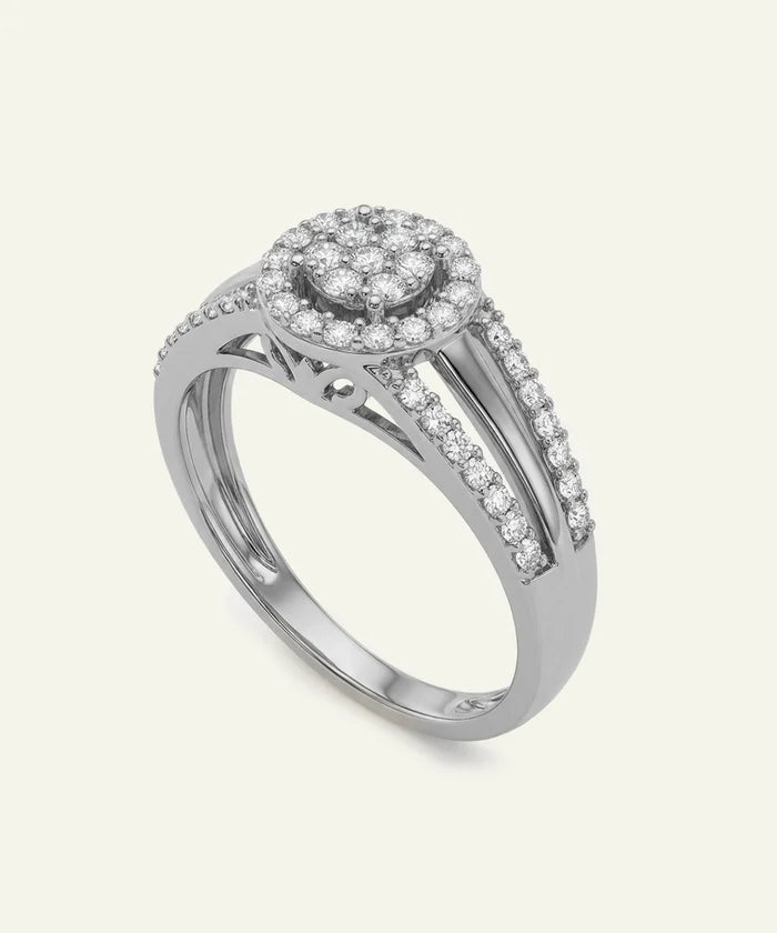 Silver ring with diamond accents on a light gray background