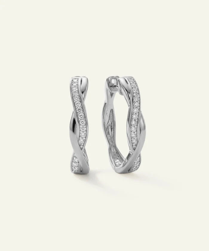 Pair of silver hoop earrings on a light gray background