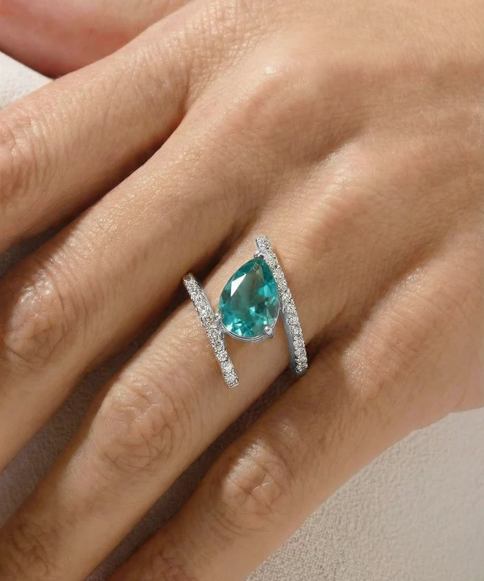 Ring with a pear-shaped blue gemstone on a hand