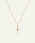 Gold necklace with a delicate pendant on a white background