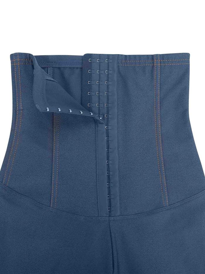 Blue high-waist denim shapewear leggings with adjustable hook-and-eye closure detail.