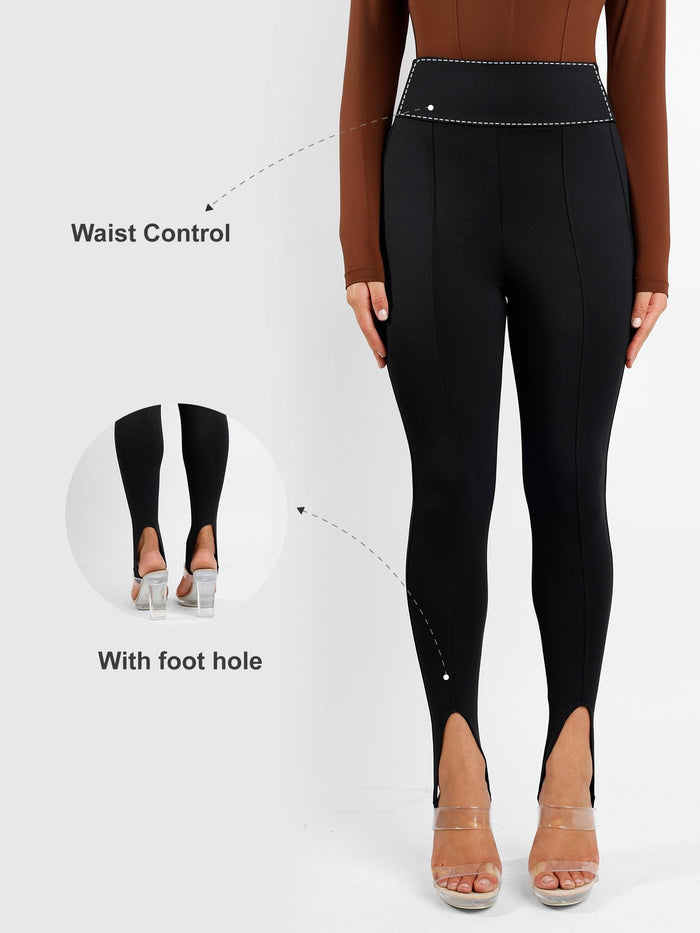 Black high rise shapewear stirrup leggings with waist control and open foot hole.