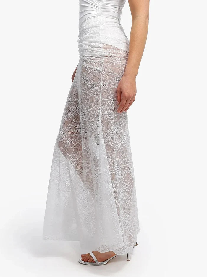 White lace fishtail maxi skirt with ruched waist detail, highlighting elegant curves and a flattering silhouette.