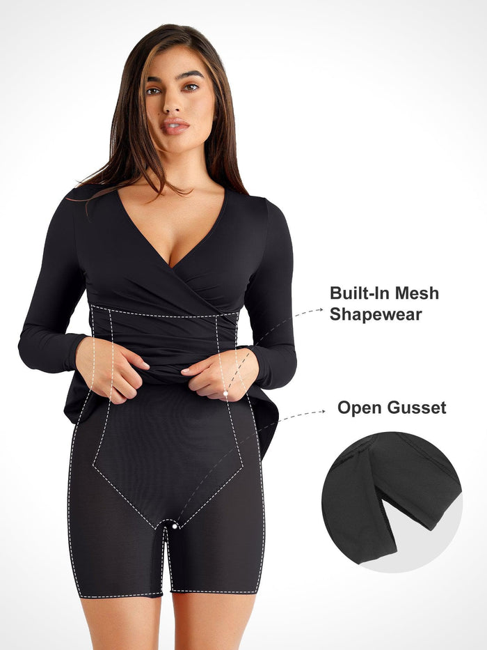 Black ruched long sleeve midi dress with built-in shapewear, faux wrap V-neck, and open gusset.