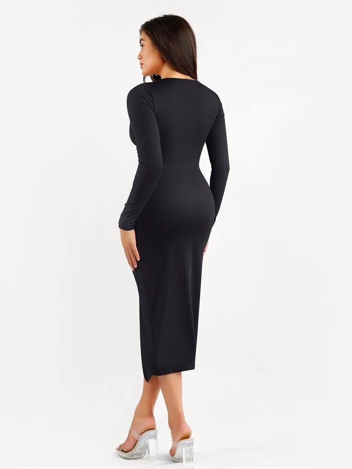 Back view of a woman showcasing the slimming silhouette of a black long sleeve ruched midi dress with built-in shapewear.