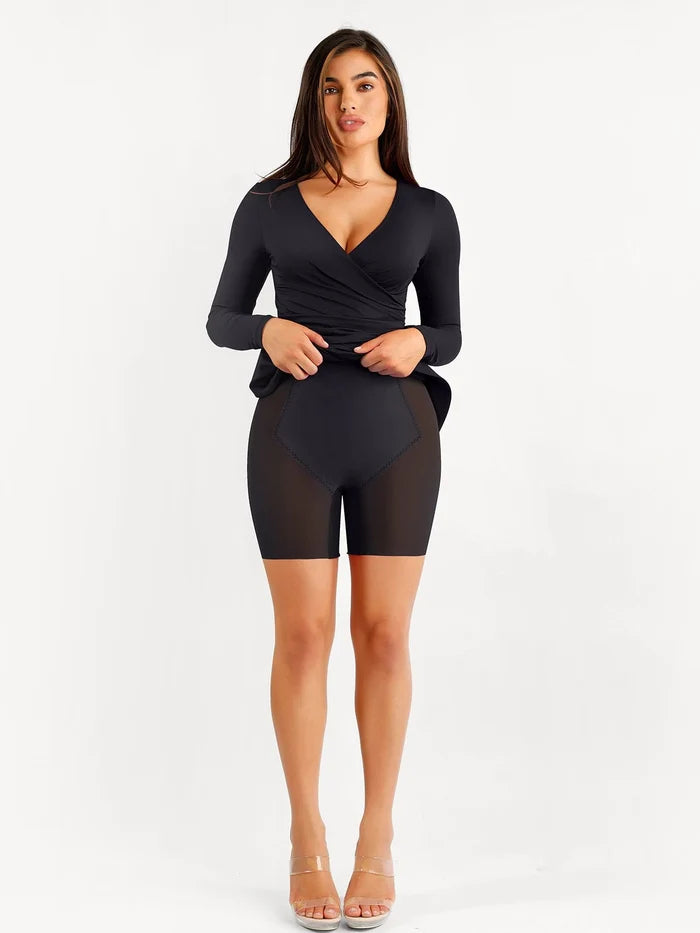 Shapewear ruched long sleeve faux wrap slimming midi dress with shorts on model.