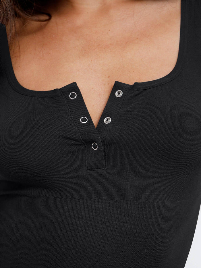 Detail of a black Henley bodysuit with adjustable neckline by Popilush®