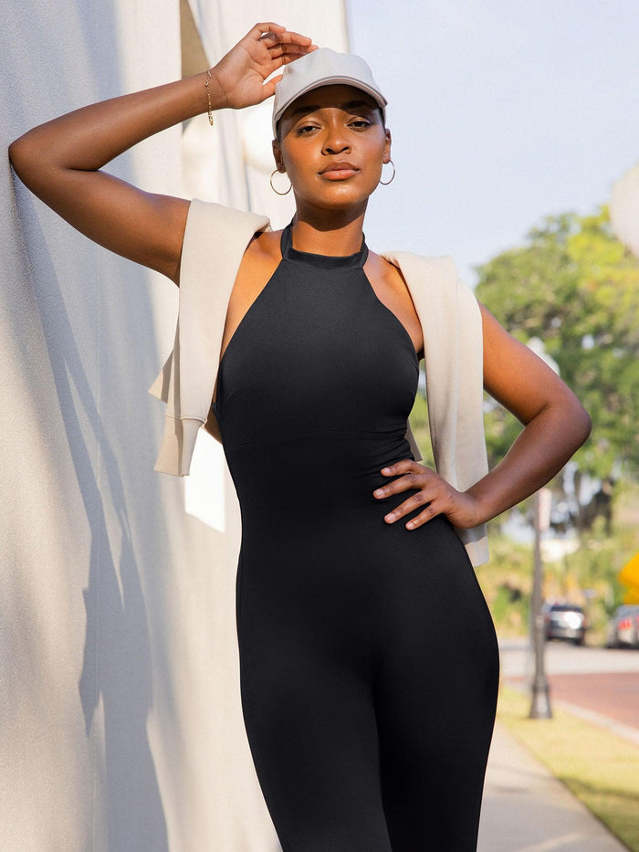 Outdoor shot of a woman in a Popilush® black shapewear jumpsuit.