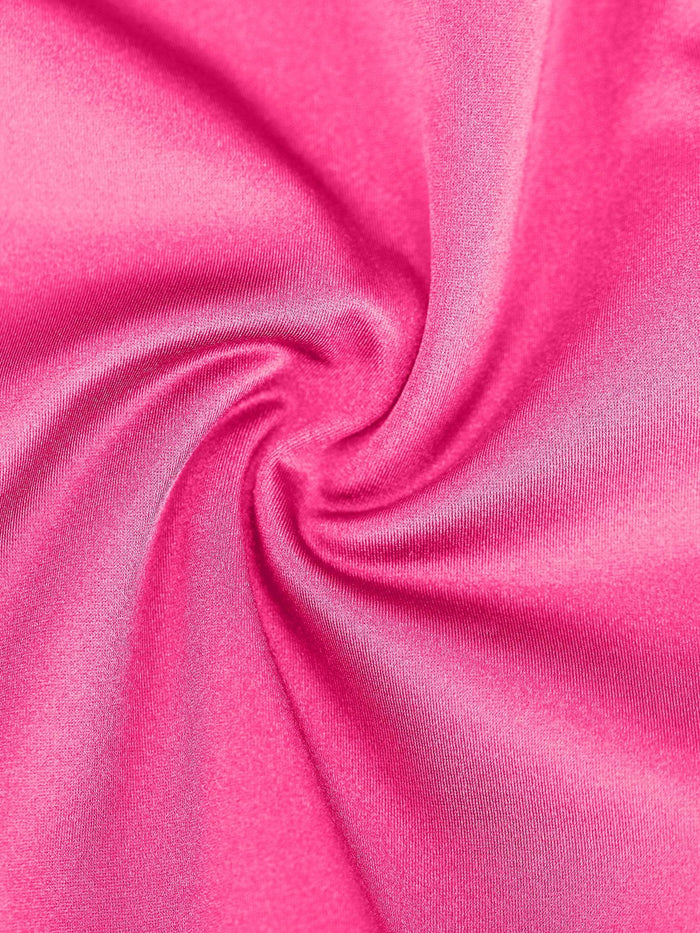 Close-up of a smooth, shiny pink fabric; a detail of a Popilush® shapewear mid-thigh romper.