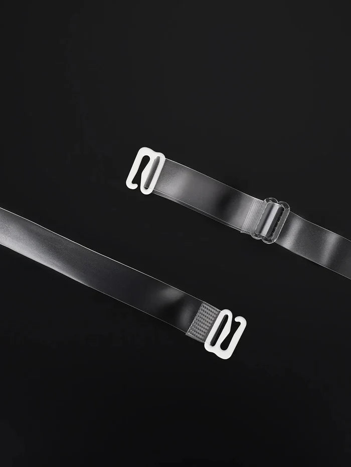 Transparent adjustable bra straps with white hooks and adjuster buckle on black background.